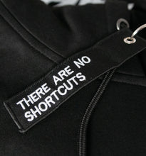 Laden Sie das Bild in den Galerie-Viewer, DER HOODIE. Oversize-Kapuzenpullover mit Aufdruck "Hoodie.", schwarz