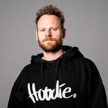 Laden Sie das Bild in den Galerie-Viewer, DER HOODIE. Oversize-Kapuzenpullover mit Aufdruck &quot;Hoodie.&quot;, schwarz
